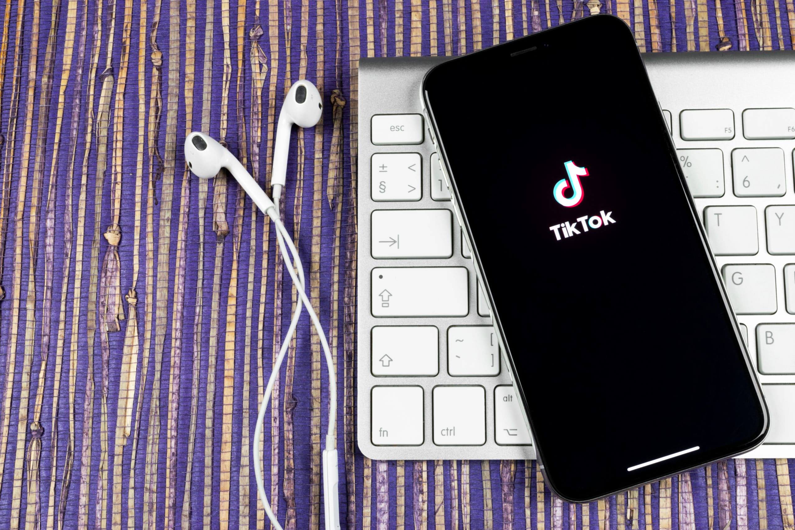 TikTok application icon on Apple iPhone X screen close-up