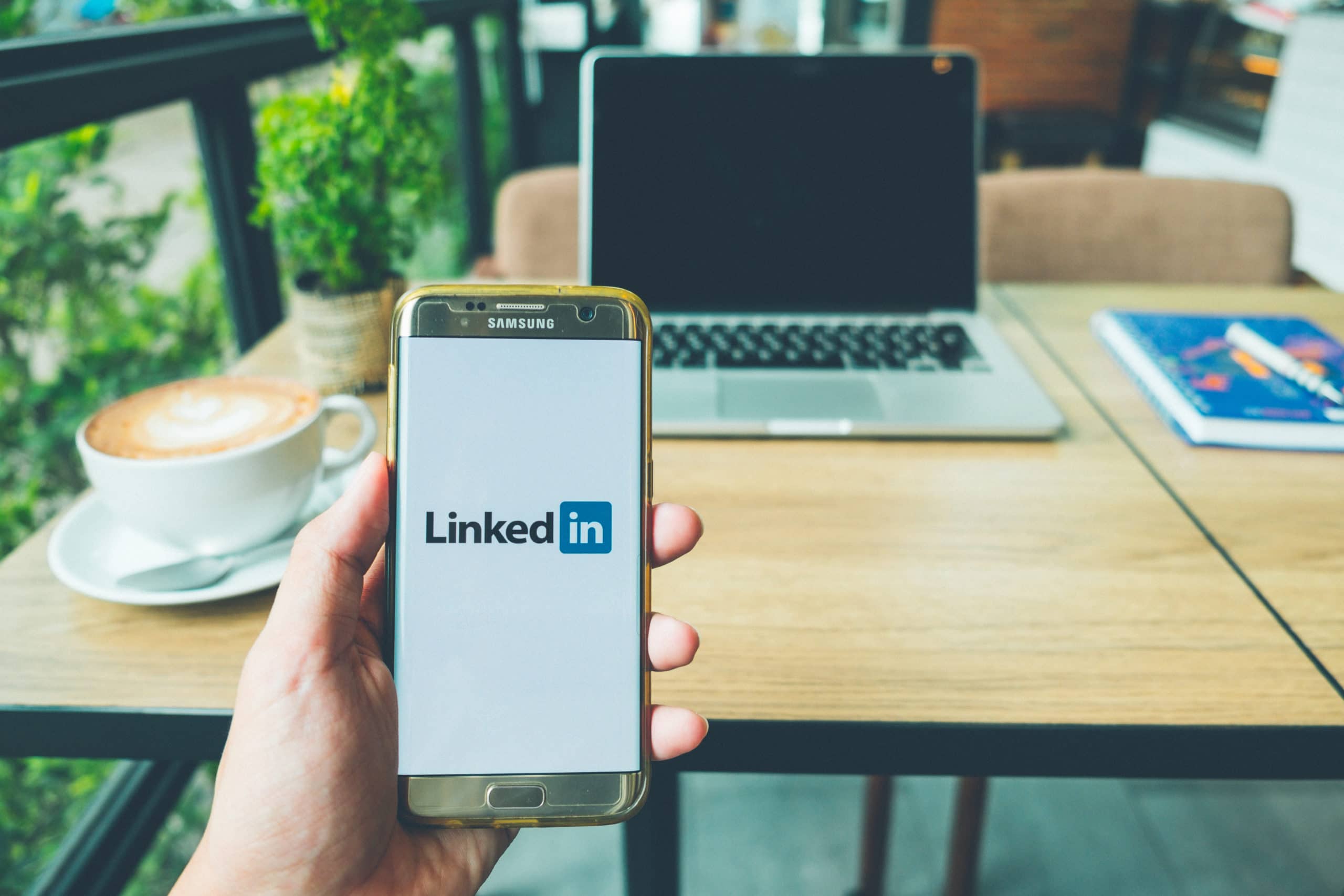 Samsung Galaxy S7 edge Mobile Phone with Linkedin application on the screen in coffee shop