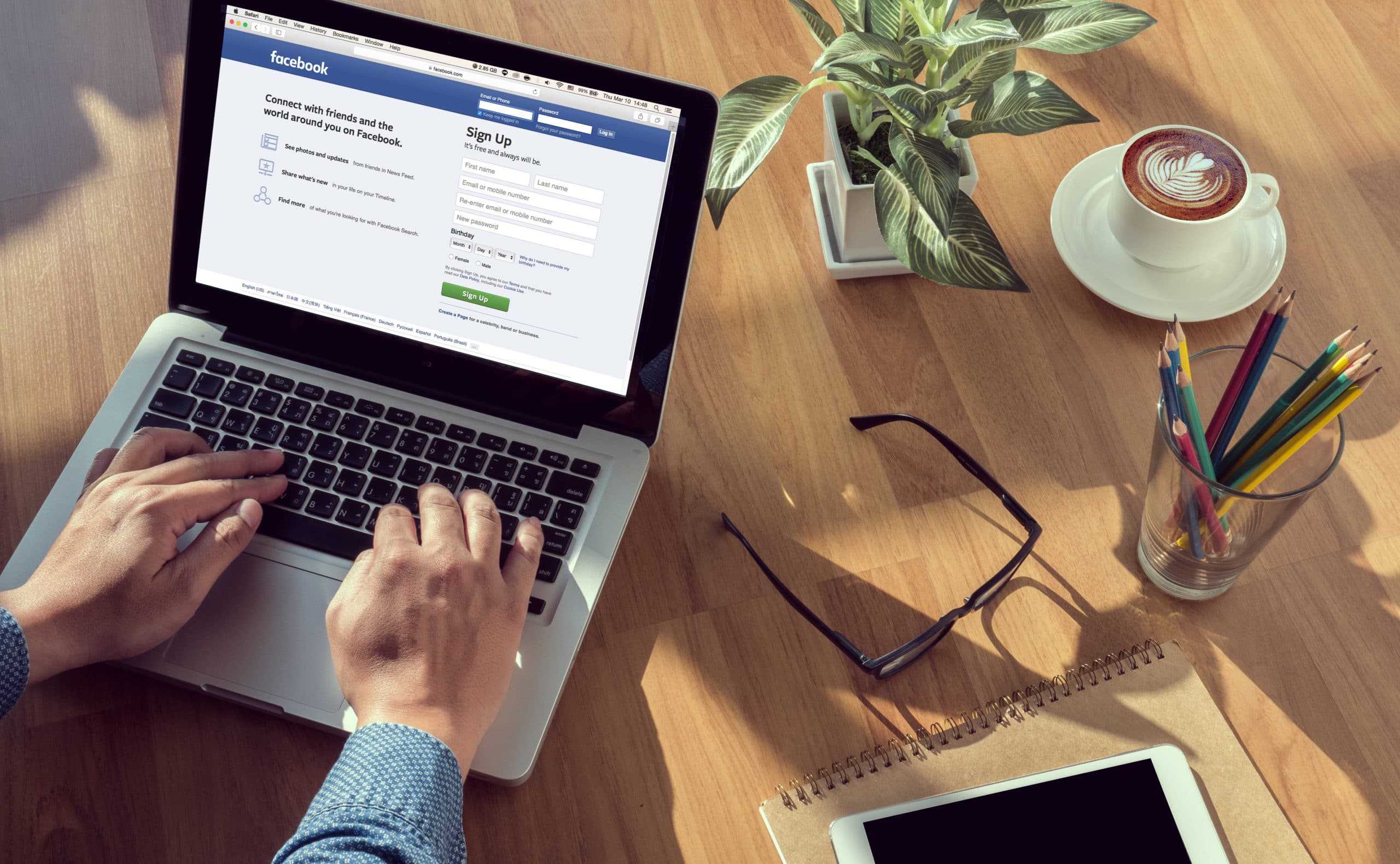 Man on a Computer Browsing Facebook Website