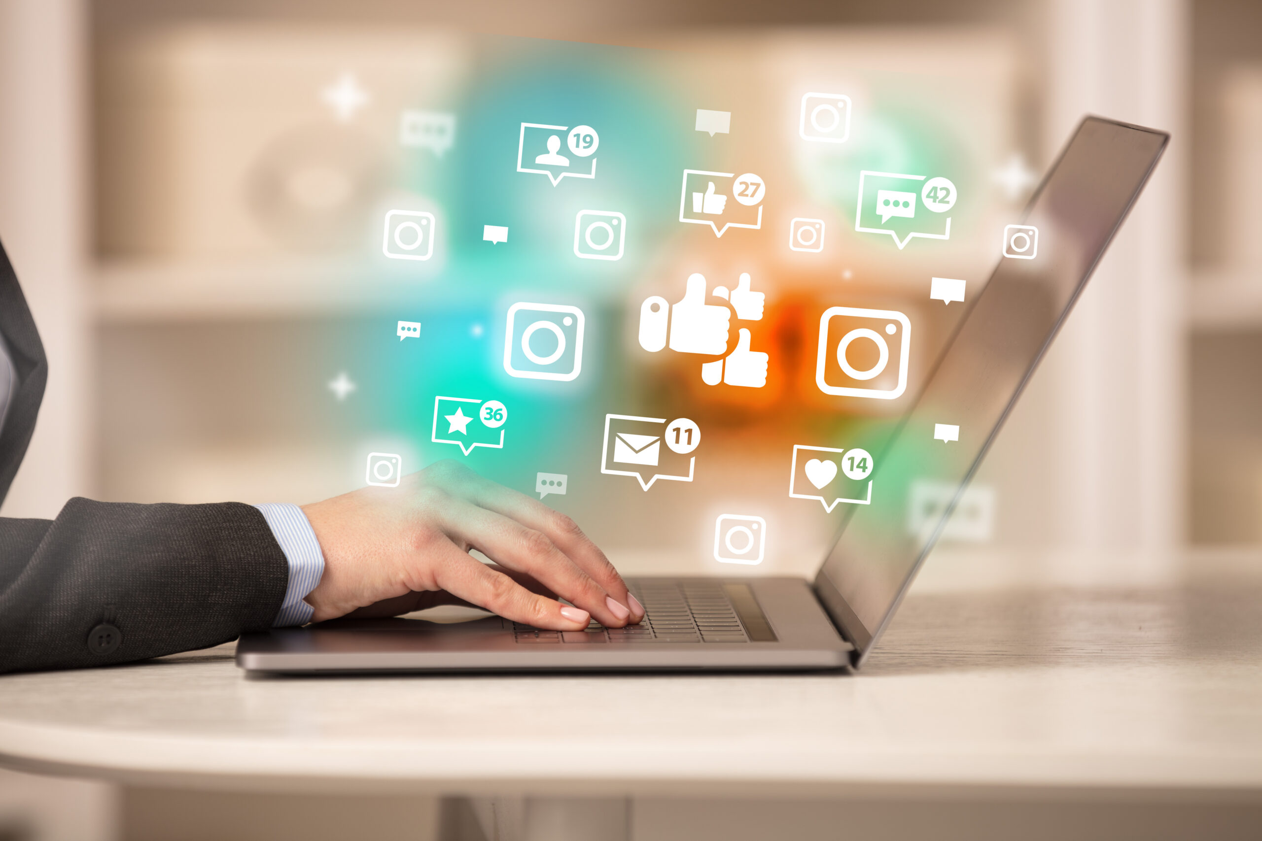 Young person surfing on laptop with likes icons, social media concept