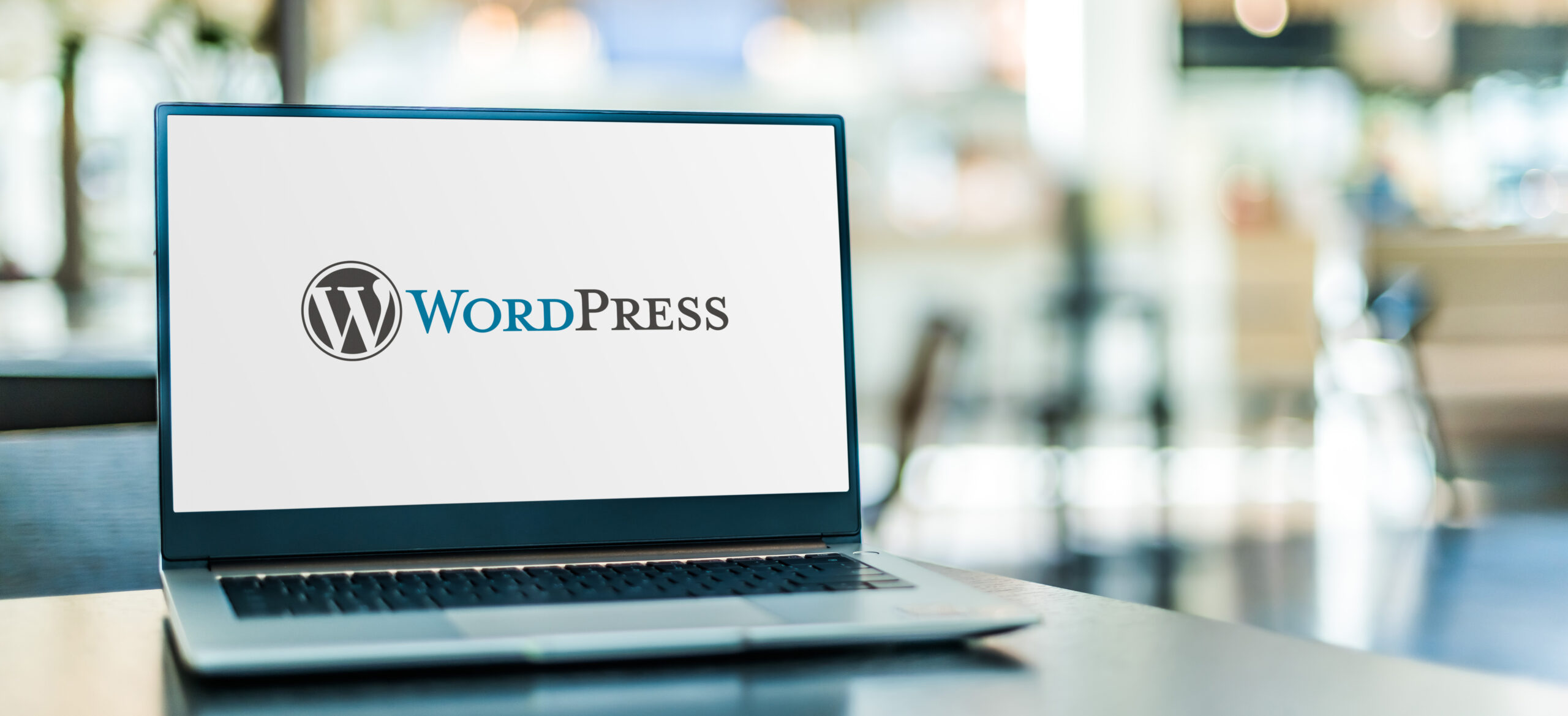 Laptop computer displaying logo of WordPress
