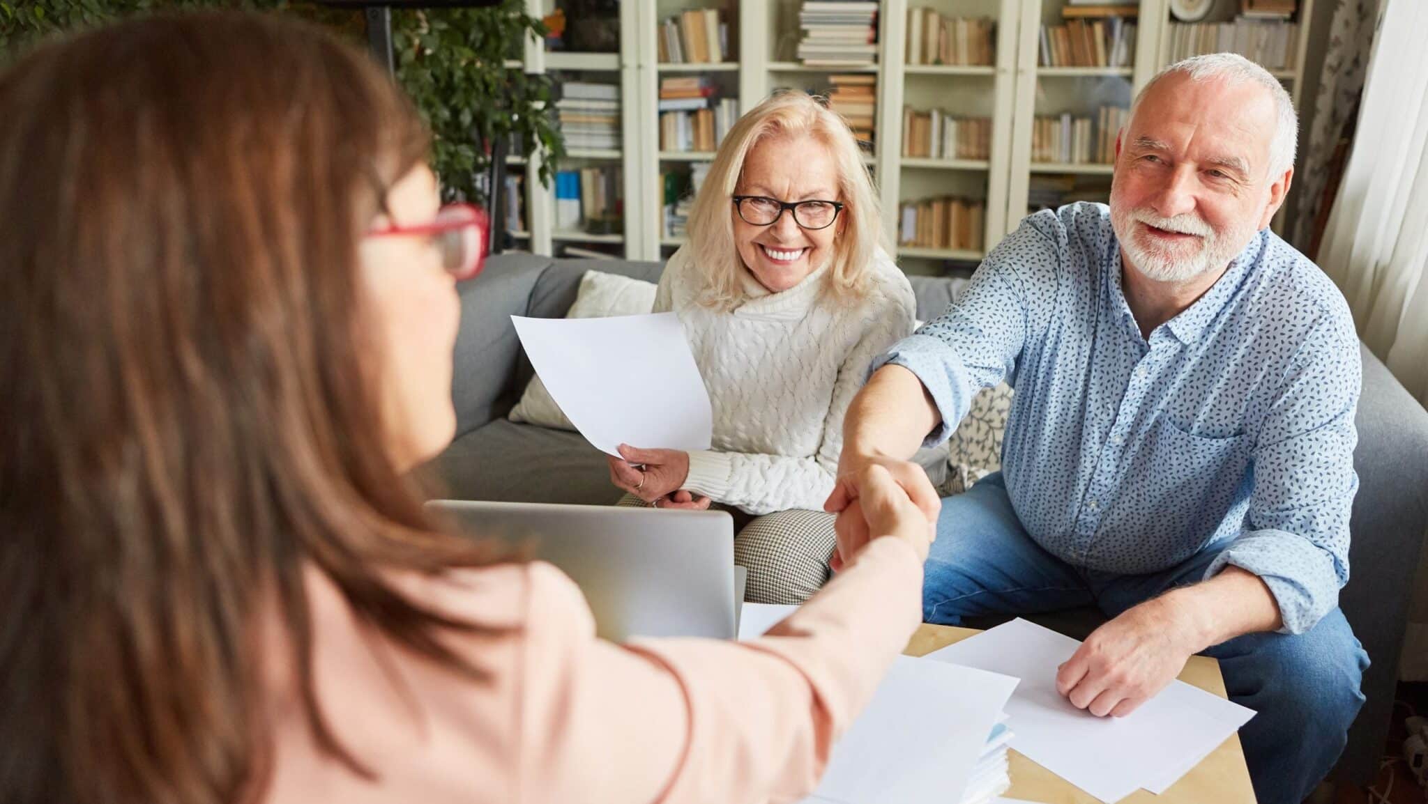 Financial advisers and seniors shake hands Financial advisers and seniors shake hands